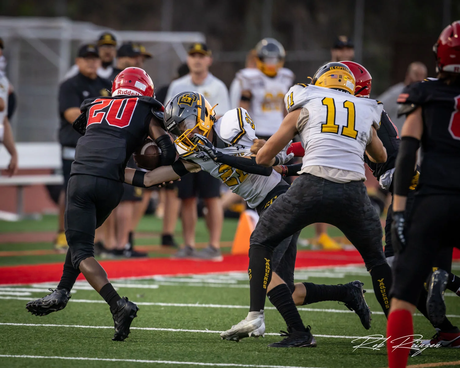 DB reaching to make the tackle while being held