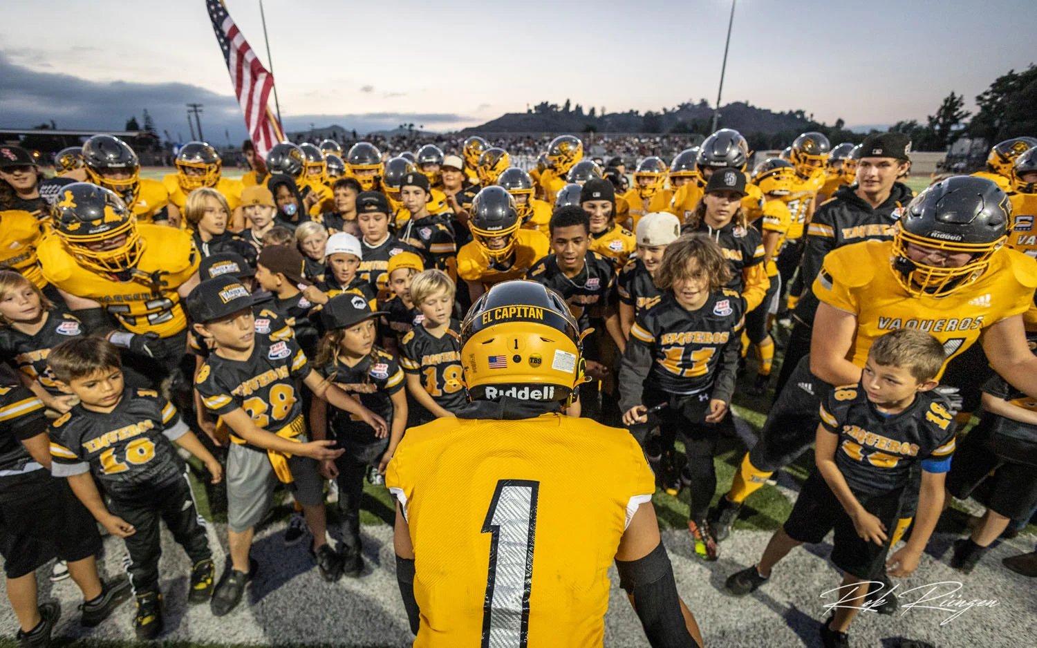 Huddle of pregame players and young players