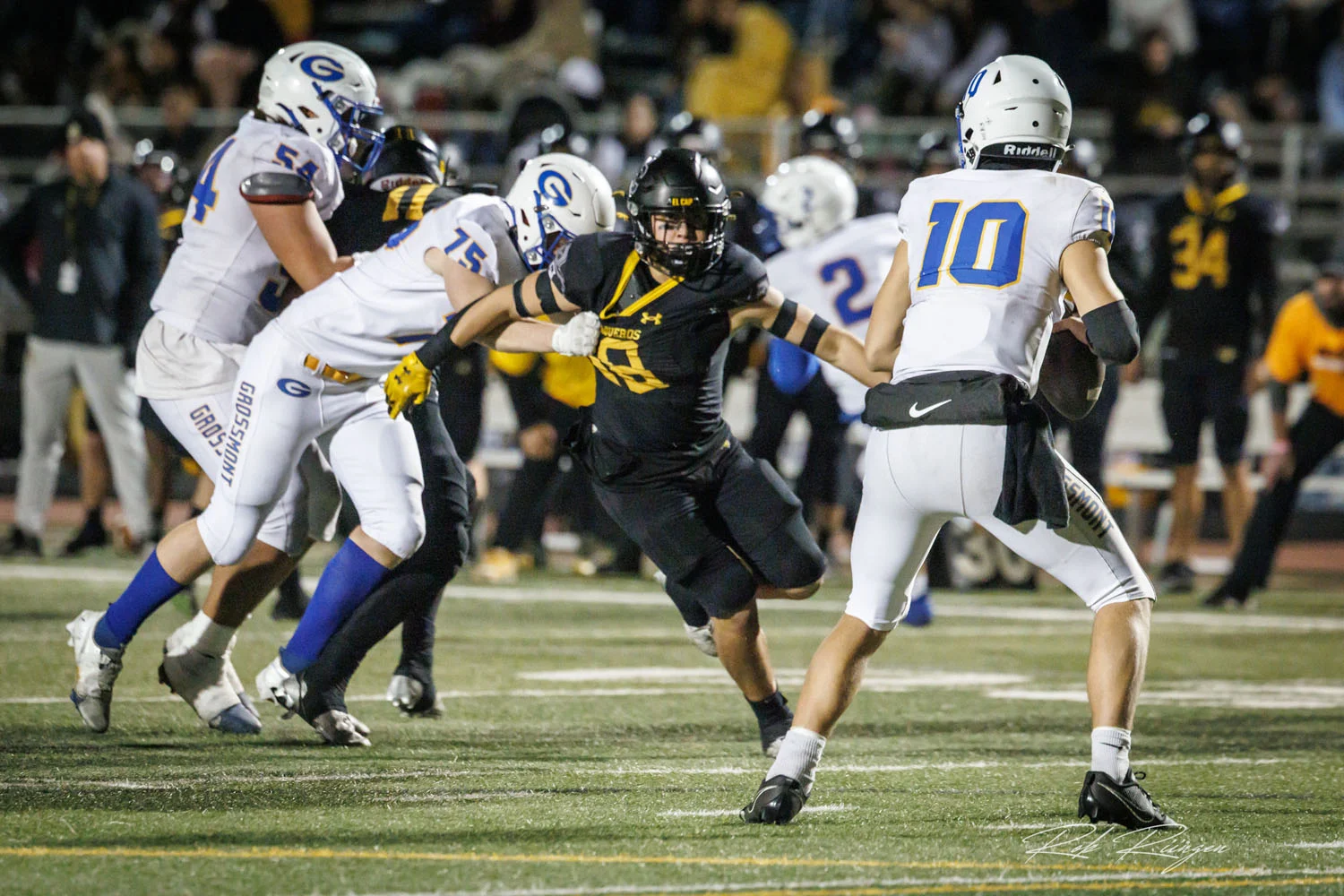 Defender being held as he gets after the QB